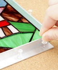 Close-up of Pro Grade Stained Glass Layout Block Kit showing template use with push pins on stained glass design.