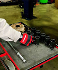 Mechanic using 8 Piece Half Inch Drive Axle Nut Socket Set With 12 Point Sockets 29mm 30mm 32mm 34mm 35mm 36mm 38mm 39mm In Case For Front Wheel Drive Vehicles Durable Case Included For Easy Transport And Organization on a tool cart