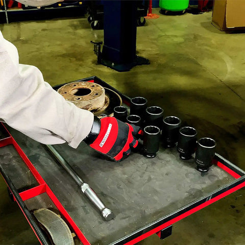 Mechanic using 8 Piece Half Inch Drive Axle Nut Socket Set With 12 Point Sockets 29mm 30mm 32mm 34mm 35mm 36mm 38mm 39mm In Case For Front Wheel Drive Vehicles Durable Case Included For Easy Transport And Organization on a tool cart