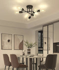 Modern chandelier in dining room with eight bulbs, above table and chairs, enhancing ambient lighting.