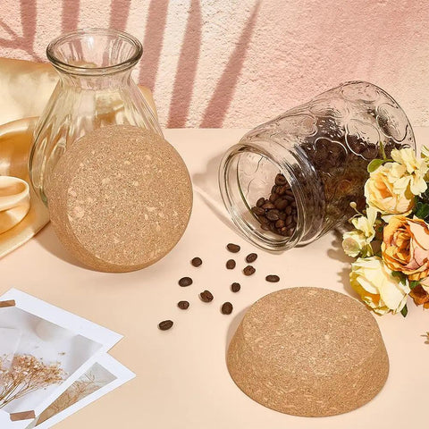 Two Pack Large Cork Stoppers For Bottles And Jars shown with glass jar and scattered coffee beans, floral decor in background.