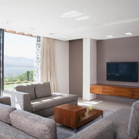 Modern living room with 4 Inch LED Recessed Lighting Kit With IC Rated Die Cast Swivel Baffle And Square Trim White 4 Pack installed