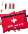Red compact first aid kit pouch with white cross, zipper and carabiner; cotton swabs shown nearby.