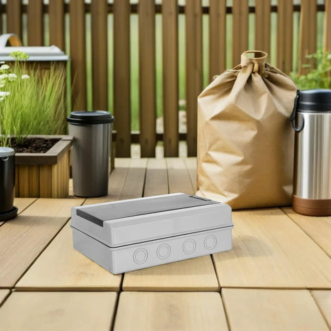 Rugged Weatherproof Outdoor Electrical Junction Box With Breaker Panel Cover on wooden deck with outdoor setting.