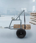 ATV Log Skidding Arch With 1600 Lbs Capacity Rugged Manual Winch showing 24 Inch Log Diameter with 16 Inch Grip Tires in warehouse.