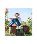 Man sitting beside Foldable Garden Kneeler With Tool Pouch And Multiple Pockets, Portable Kneeling Stool Bench For Gardening outdoors.