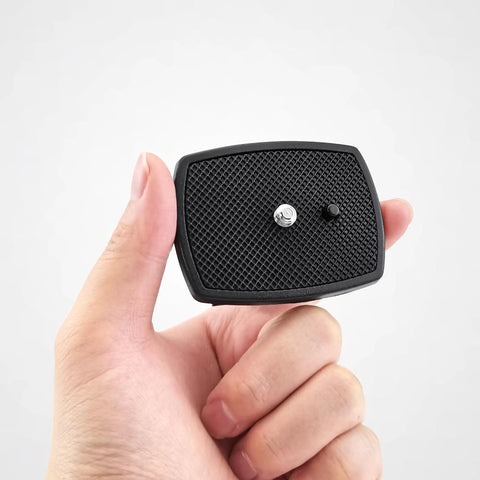 Hand holding Non Slip Camera Quick Release Plate 43mm For Tripods And Cameras No Hassle Quick Attach Secure Mount Lightweight Plastic