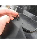 Hand installing a solid nylon bumper fastener clip on a vehicle part from the Solid Nylon Bumper Fastener Clips 100 Piece Set Replaces GM And Ford Rivets Comes With Free Remover Tool No Sweat Easy Install Drop In Fitment For Any Weekend Grease Monkey Or Pro Shop.