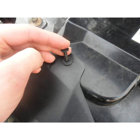 Hand installing a solid nylon bumper fastener clip on a vehicle part from the Solid Nylon Bumper Fastener Clips 100 Piece Set Replaces GM And Ford Rivets Comes With Free Remover Tool No Sweat Easy Install Drop In Fitment For Any Weekend Grease Monkey Or Pro Shop.