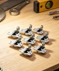 Soft Close Cabinet Hinges Set For Kitchen Cupboards on wooden surface, precision matched holes, no drill needed, durable design
