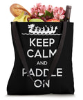 Racing Inspired Tote Bag For Fans And Racers With Festive Dragon Boat Festival Design Durable Canvas Carryall For Events Training And Weekend Adventures featuring black tote with 'Keep Calm and Paddle On' text with groceries inside