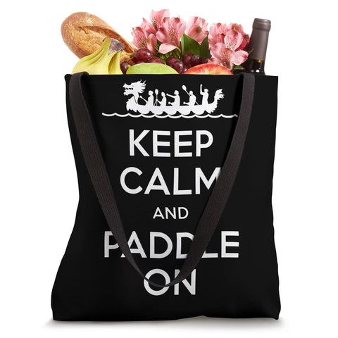 Racing Inspired Tote Bag For Fans And Racers With Festive Dragon Boat Festival Design Durable Canvas Carryall For Events Training And Weekend Adventures featuring black tote with 'Keep Calm and Paddle On' text with groceries inside