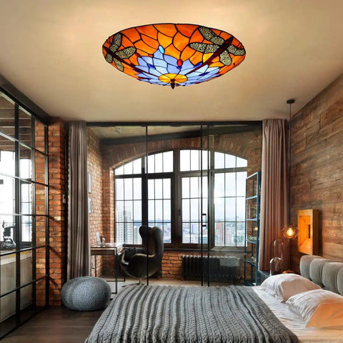 Dragonfly 3 Light Flush Mount Ceiling Light With Orange Stained Glass Shade 16 Inch Fixture in cozy living room