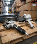 Heavy Duty Pneumatic Steel Strapping Machine With Tensioner Cutter And Sealer Set on a wooden pallet with steel strap.