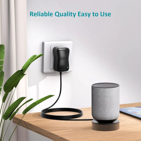 Do It All 24W AC To DC Power Adapter Kit plugged into wall near speaker on table