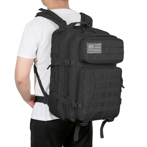 Person wearing 45L Military Tactical Backpack With MOLLE System For Bug Out Ready Black Rucksack Army Assault Pack For Hiking And Trekking Durable Rucksack With Large Multi Layer Interior Storage