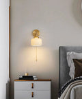 Total Game Changer Modern Wall Sconce Lights For Indoor Spaces sleek French copper finish glowing softly above bedside table