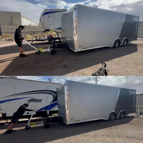 Person using Monster Tug Off-Road Trailer Dolly to maneuver a large silver trailer on gravel surface.