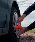 Person using Dead Blow Hammer 4 Lb Mallet With Non Marring Rubber Coating for metal work on car wheel with orange grip for scratch-free taps