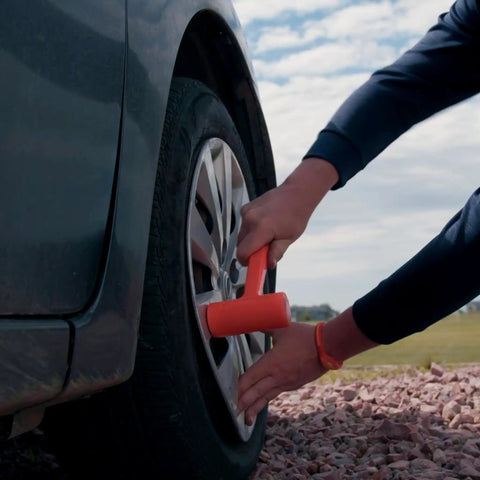 Person using Dead Blow Hammer 4 Lb Mallet With Non Marring Rubber Coating for metal work on car wheel with orange grip for scratch-free taps