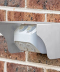 Heavy Duty Stainless Steel Weather Sealed Electrical Box Cover Rainproof Outlet Shell protecting outdoor socket mounted on a brick wall.