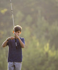 Boy using Youth Spincast Fishing Rod And Reel Ike Dude 5 Foot 6 Inch 2 Piece Easy To Learn Kid Friendly Combo outdoors