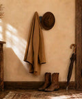 Rustic entryway showing Built Tough 4 Pack Western Bull Horn Hat Hooks In Matte Black Cast Iron Wall Rack with coat and hat.
