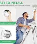 Installing 12 Pack Br30 LED Recessed Light Bulbs Dimmable Can Lights Soft White 2700K 650 Lumens E26 into ceiling fixtures.