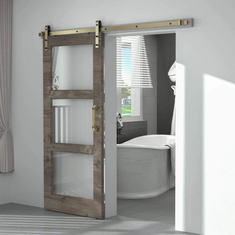 Brass Sliding Barn Door Hardware Kit In Brushed Gold Finish installed on wooden door in bathroom, carbon steel track visible