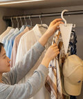 Slick V Shaped Double Sided Clothes Hanger With Twelve Hooks for easy access to scarves and hats in a closet.