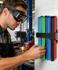 Person organizing welding rods on wall rack in workshop