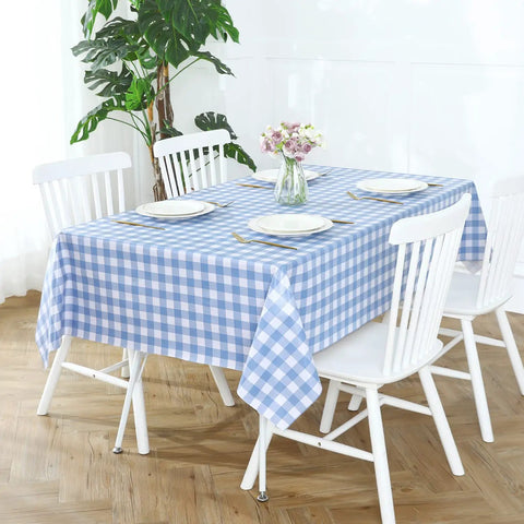 Buffalo Gingham Waterproof Vinyl Tablecloth Heavy Duty Wipeable Checkered Table Cover Outdoor Patio Picnic Camping 54 X 78 Inches Light Blue Spillproof PVC Protector on dining table with white chairs and floral centerpiece.