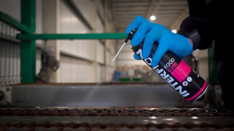 Person using NSF H1 Food Grade Dry Film Lubricant For Food Processing Equipment Multipurpose Aerosol Can 500ml on machinery.