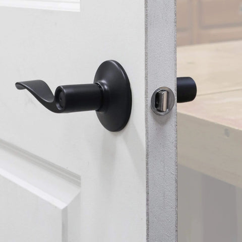 Close-up of a black door handle installed using Door Lock Installation Kit With Jig For Wood And Metal Doors Fits Standard Doors