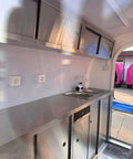 Interior of Kickstart Your Mobile Eatery Hustle With This Custom Food Vending Trailer And Commercial Catering Cart showing stainless steel counters and sink.