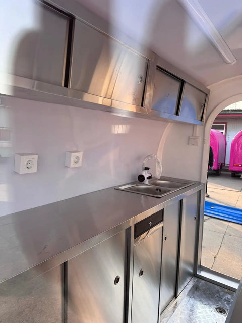 Interior of Kickstart Your Mobile Eatery Hustle With This Custom Food Vending Trailer And Commercial Catering Cart showing stainless steel counters and sink.