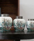 Large Ceramic Kitchen Storage Jars With Dual Sealed Alloy Lids Keep Your Tea Coffee Beans And Candy Stash Nice And Crisp In This Heavy Duty Pantry Setup, three artistic canisters on a table.
