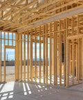 Wooden frame construction interior for future building with open layout and natural light