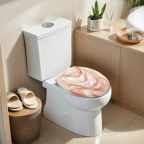 Elongated Liquid abstract marble painting print rose gold Toilet Seat on modern white toilet in bright bathroom setting.