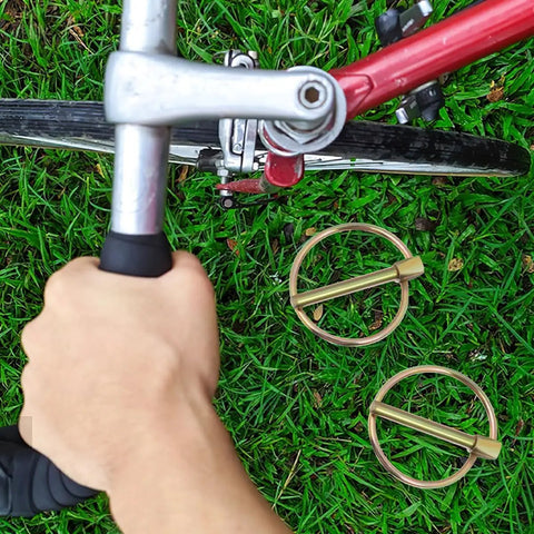 12 Pack Heavy Duty Linch Pin Kit With Ring 3/16 Inch Carbon Steel Locking Pins next to a bicycle on grass
