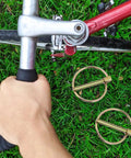 12 Piece Lynch Pin Set 3 Sixteenth Inch Heavy Duty Carbon Steel Locking Trailer Hitch Pins on grass near bike