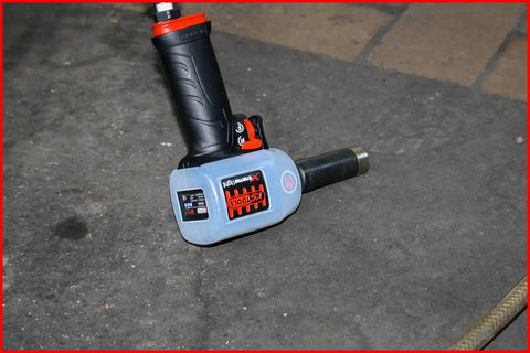 Pro Shop Essential 1/2 Drive Pneumatic Impact Wrench on a workshop floor showcasing ergonomic grip and durable design.