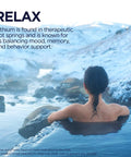 Person relaxing in hot springs with snowy landscape, text about lithium's mood and behavior support benefits.