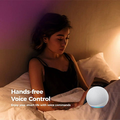 Person reading in bed using voice control with smart device by their side