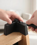 Close-up of installing L Shaped Plastic Furniture Legs Set Four Pieces with M5 screws on wooden table corner