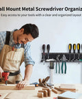 Man working in a workshop with a Wall Mount Tool Organizer for Screwdrivers and Pliers Easy Install Space Saving Wall Rack behind him.