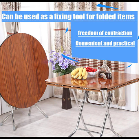 Room with folded wooden table top leaning against folding table, showcasing Four Pack Drop Leaf Table Supports And Folding Hinges Kit With 180 Degree Cross Spring Hinges And Mounting Screws Heavy Duty Iron Die Cast Zinc Plated Built For Durable Kitchen Workshop Or Patio Tables.