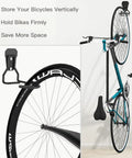 Heavy Duty Bike Wall Mount With Fixed Hook 2 Pack Iron Bike Hanger Brackets For Garage Vertical Storage Rack To Easily Hang And Detach Screws Included Sturdy Wall Mounting System For Secure Bike Storage, installed with bicycle vertically on wall.