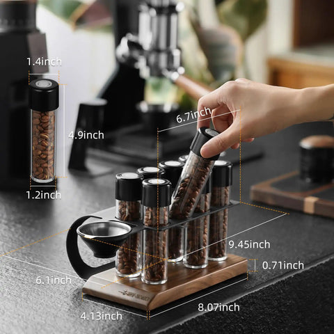 Single Dose Coffee Storage Tubes With One Way Exhaust Valve 8 Piece Set, espresso dosing jars in walnut holder on countertop.