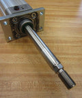 Bosch Rexroth Double Acting Cylinder 523-111-050-0 with 1/4 NPT port, close-up of 3/4 inch shaft and mounting plate on wood surface